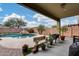 Backyard featuring a beautiful pool, lush landscaping, and a covered patio at 29437 W Columbus Ave, Buckeye, AZ 85396