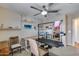 Room featuring ceiling fan, wall shelves, plantation shutters, and multiple work surfaces at 29437 W Columbus Ave, Buckeye, AZ 85396