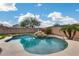 Sparkling pool with a rock feature, providing a focal point for a tranquil and inviting outdoor space at 29437 W Columbus Ave, Buckeye, AZ 85396