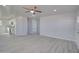 Open-concept living space showcasing gray laminate flooring and updated lighting at 3355 W Tollan Dr, Eloy, AZ 85131