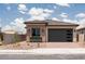Charming single-story home with a tan exterior, desert landscaping, and a two-car garage at 338 E Las Perlas Ln, San Tan Valley, AZ 85140