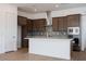 Modern kitchen featuring dark cabinets, a white island, stainless steel appliances, and tile backsplash at 338 E Las Perlas Ln, San Tan Valley, AZ 85140
