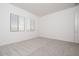 Bright bedroom with plush carpeting and natural light from two windows with stylish window treatments at 352 E Las Perlas Ln, San Tan Valley, AZ 85140