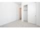 Bright bedroom with light carpet, a closet with sliding doors, and access to another room at 352 E Las Perlas Ln, San Tan Valley, AZ 85140