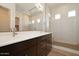 Modern bathroom featuring double vanity, large mirror, and glass-enclosed shower with tile at 366 E Las Perlas Ln, San Tan Valley, AZ 85140
