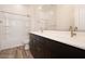 This bathroom features double sinks, dark cabinetry, and tub with shower at 366 E Las Perlas Ln, San Tan Valley, AZ 85140