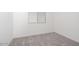 A sunlit bedroom with gray carpet and bright white walls with a window that gives great natural light at 366 E Las Perlas Ln, San Tan Valley, AZ 85140