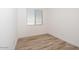 Cozy bedroom with wood-look floors and a window with blinds at 366 E Las Perlas Ln, San Tan Valley, AZ 85140