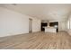 Spacious living area with wood-look floors and an open floor plan to the kitchen at 366 E Las Perlas Ln, San Tan Valley, AZ 85140