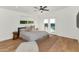 Bright bedroom features a ceiling fan, neutral walls, light-colored bedding, and backyard access at 37 Spur Cir, Scottsdale, AZ 85251