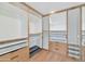 Well-organized walk-in closet with custom shelving and drawers for optimal storage at 37 Spur Cir, Scottsdale, AZ 85251