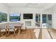 Sunlit dining area with a built-in bench and views of the outdoor pool area at 37 Spur Cir, Scottsdale, AZ 85251