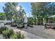 Charming garden with raised beds, stone pathways, and shady umbrellas, creating a serene outdoor space at 37 Spur Cir, Scottsdale, AZ 85251