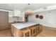 Modern kitchen with a large central island, wooden stools, and pendant lighting at 37 Spur Cir, Scottsdale, AZ 85251