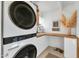 Bright laundry room equipped with modern washer and dryer, countertop, and storage cabinets at 37 Spur Cir, Scottsdale, AZ 85251