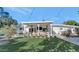 Expansive covered patio offers an outdoor lounge area with stylish seating, an outdoor fan, and backyard access at 37 Spur Cir, Scottsdale, AZ 85251