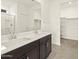 Modern bathroom featuring a dual sink vanity and a closet at 37098 W Prado St, Maricopa, AZ 85138