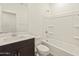 Clean bathroom featuring a sleek vanity, toilet, and a shower-tub combo at 37098 W Prado St, Maricopa, AZ 85138