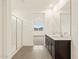 Bright bathroom featuring a glass shower and dual sink vanity at 37098 W Prado St, Maricopa, AZ 85138