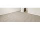 A view of a carpeted bedroom with a glimpse of the bathroom vanity at 37098 W Prado St, Maricopa, AZ 85138