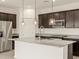 Kitchen featuring stainless steel appliances, granite countertops and large island at 37098 W Prado St, Maricopa, AZ 85138