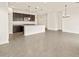 Open kitchen featuring dark cabinets, granite countertops, stainless appliances, and large island at 37098 W Prado St, Maricopa, AZ 85138