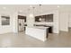 Kitchen featuring granite countertops, stainless steel appliances, large island with seating and dark cabinets at 37098 W Prado St, Maricopa, AZ 85138