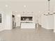 Open living room to kitchen featuring an island with granite countertops and stainless appliances at 37098 W Prado St, Maricopa, AZ 85138