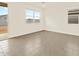 Bright living room featuring tile flooring and sliding glass doors at 37098 W Prado St, Maricopa, AZ 85138