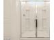 Clean and bright walk-in shower with glass door and tile surround at 37098 W Prado St, Maricopa, AZ 85138