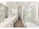 Bright bathroom featuring double vanity, walk-in shower, soaking tub, and a walk-in closet at 3746 E Rochelle Cir, Mesa, AZ 85215