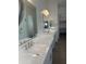 Bright bathroom boasts dual sinks, modern lighting and a separate toilet area at 3746 E Rochelle Cir, Mesa, AZ 85215