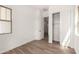Well-lit bedroom with wood-look flooring, neutral tones, and closet with sliding doors at 3746 E Rochelle Cir, Mesa, AZ 85215