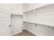 A walk-in closet with white shelving and wood-look flooring for organized storage at 3746 E Rochelle Cir, Mesa, AZ 85215