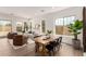 Open-concept dining area with a wooden table, black chairs, and ample natural light at 3746 E Rochelle Cir, Mesa, AZ 85215