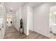 Bright hallway featuring tile floors, white walls, and views to other rooms in the home at 3746 E Rochelle Cir, Mesa, AZ 85215