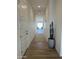 Bright hallway with wood-look tile flooring and decorative cactus at 3746 E Rochelle Cir, Mesa, AZ 85215