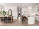 Bright, modern kitchen with white cabinetry, granite countertops, and a dining area with black chairs at 3746 E Rochelle Cir, Mesa, AZ 85215