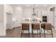 Bright kitchen showcases white cabinets, granite countertops, stainless steel appliances, and bar stool seating at 3746 E Rochelle Cir, Mesa, AZ 85215