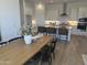 Open-concept kitchen with bar seating flows into dining area with a wooden table at 3746 E Rochelle Cir, Mesa, AZ 85215