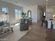 Sunlit living room with a large window and open layout to the dining area at 3746 E Rochelle Cir, Mesa, AZ 85215