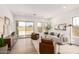 Bright living room featuring neutral colors, tile floors, and sliding glass doors to the backyard at 3746 E Rochelle Cir, Mesa, AZ 85215