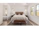 A serene main bedroom featuring neutral tones, a woven headboard, and ensuite bathroom with soaking tub at 3746 E Rochelle Cir, Mesa, AZ 85215