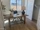 Well-lit home office with a wooden desk and a view of the outdoors at 3746 E Rochelle Cir, Mesa, AZ 85215
