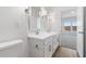 Bathroom featuring a double sink vanity with wooden floors, modern lighting fixtures, and a toilet at 3937 S 233Rd Ln, Buckeye, AZ 85326