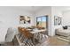 A stylish dining room complemented by a modern table set with seating for eight at 3937 S 233Rd Ln, Buckeye, AZ 85326