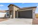 A lovely home with a stone facade, a two-car garage, and a concrete driveway at 3937 S 233Rd Ln, Buckeye, AZ 85326