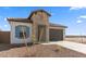 A charming single-story home with a stone facade, 2-car garage, and minimal desert landscaping at 3937 S 233Rd Ln, Buckeye, AZ 85326