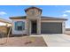 Charming single story home featuring a stone facade, 2-car garage, and low maintenance desert landscaping at 3937 S 233Rd Ln, Buckeye, AZ 85326