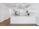 Bright kitchen with stainless steel appliances, white cabinetry, quartz countertop, and hardwood floors at 3937 S 233Rd Ln, Buckeye, AZ 85326